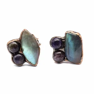 Detailed macro shot of an irregular copper ring with natural labradorite and amethyst