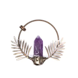 Detailed view of vintage bronze pendant with natural purple amethyst crystal point
