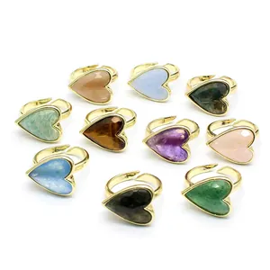Set of gold-plated heart-shaped rings with various natural gemstones in vintage style.