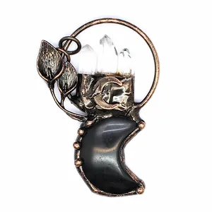 Detailed macro view of vintage bronze moon pendant featuring natural quartz crystals