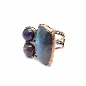 Detailed close-up of a vintage copper ring featuring irregular labradorite and amethyst stones