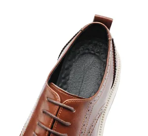 Close-up of brown leather brogue shoe showing stitching and interior texture detail.
