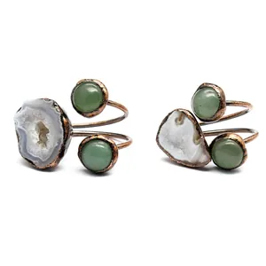 Detail of natural druzy agate and green stone spiral rings with bronze finish.