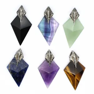 Detailed view of assorted natural stone pendants with Poseidon trident metal caps.