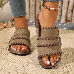 Close-up view of women's vintage open-toe sandals with stylish contrast stitching.