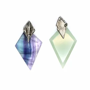 Detailed view of two kite-shaped natural stone pendants with trident metal bails