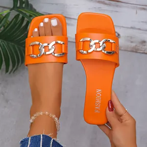 Close-up view of the orange square toe flat slide sandals featuring a stylish silver chain link