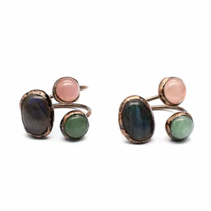 Detailed macro shot of vintage copper rings featuring three natural semi-precious stones