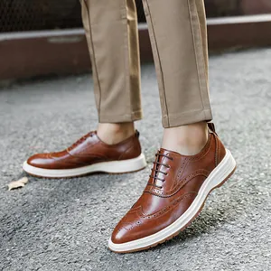 Stylish men's brown wingtip brogues with a chunky white sole for casual business wear