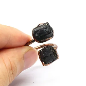 Detail view of vintage adjustable ring with raw black gemstones and bronze finish