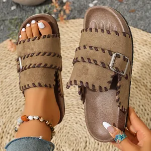 Detail view of retro brown suede Birkenstock-style slide with braided stitching