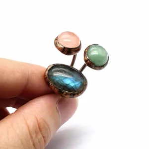Close-up of a three-stone natural labradorite ring with antique copper rustic finish