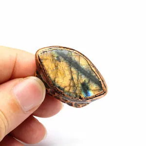 Close-up detail of a vintage labradorite stone ring with a hammered antique copper band