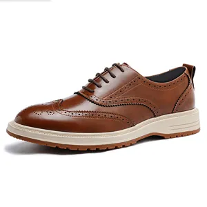 Men's classic brown leather brogue shoes with wingtip detailing on white background