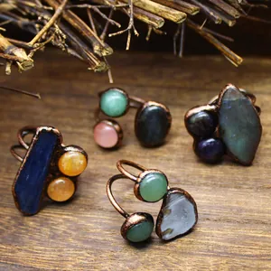 Macro detail view of vintage copper rings featuring natural irregular gemstones