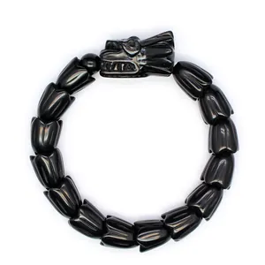 Detailansicht eines schwarzen Steinarmbands mit fein geschnitztem Drachenkopf und Blütenperlen
