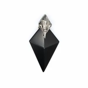 Close-up detail of a geometric black obsidian stone pendant with a silver trident-style bail