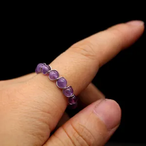 Nahaufnahme von natürlichen Amethystperlen auf einem handgefertigten, offenen Kristallring