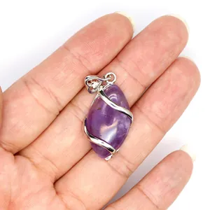 Close-up shot of a marquise cut amethyst pendant with silver wire wrap and hollow bail