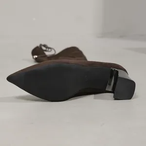 Detailed view of brown suede boot sole and chunky heel with size 37 mark.