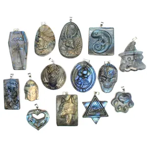 Variety of carved natural labradorite stone pendants with mystical animal and skull designs.