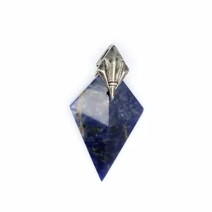 Close-up of a blue natural stone pendant featuring a silver trident-style metal clasp.