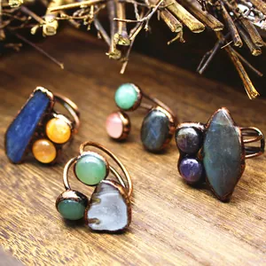 Detailed close-up of irregular natural crystal and agate rings with vintage bronze finish