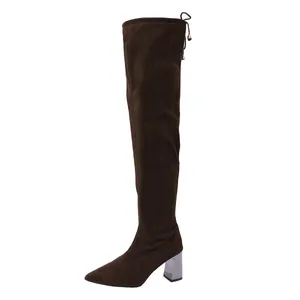 Elegant brown suede over-the-knee boots with chunky metallic silver heel and back tie