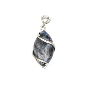 Detailed view of a marquise shaped natural blue stone pendant with heart filigree filigree bail.
