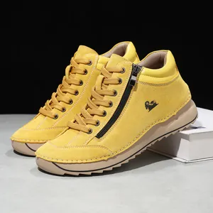 Detailed view of yellow suede leisure shoes with handmade stitching and side zipper