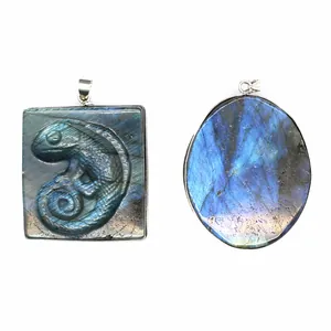 Detailed view of natural labradorite pendants with intricate chameleon carving and blue flash
