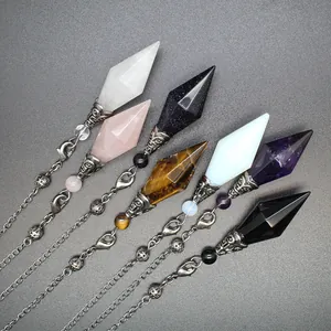Detail showing multi-color double-pointed crystal dowsing pendulums with silver metal chains.