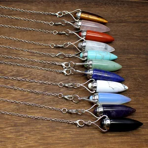 Close-up of bullet-shaped natural stone crystal pendulum pendants in eleven vibrant colors.