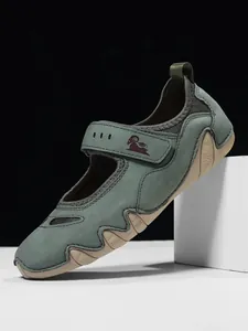 Side view of sage green Mary Jane casual shoe with hook-and-loop strap and wavy sole