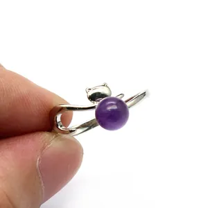 Detailed view of a silver fox shaped adjustable ring holding a round purple amethyst stone