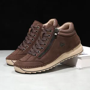 Macro detail view of brown handmade stitched suede casual shoes with side zipper