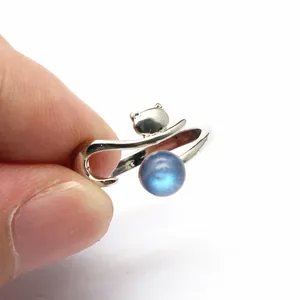 Close-up detail of a silver-toned fox-shaped open ring with a blue natural stone bead