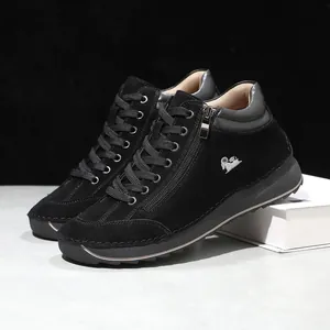 Detail of black suede casual shoes with side zipper and hand-stitched sole