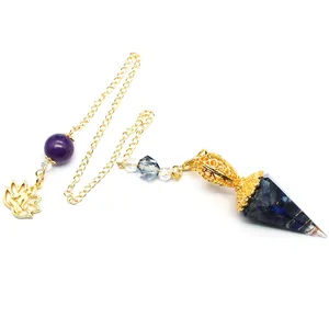 Detailed close-up of a blue resin hexagonal dowsing pendulum with gold chain and lotus charm.