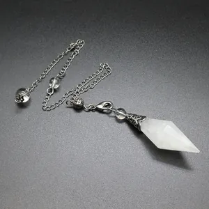 Close-up of a double pointed white crystal pendulum with retro silver chain.