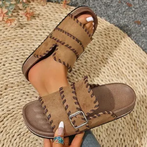 Close-up of retro brown platform sandals with contrast stitching and buckle detail