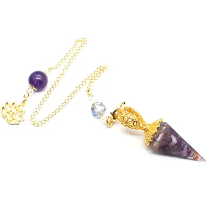 Macro detail of amethyst resin hexagonal cone pendulum with gold chain and lotus charm.