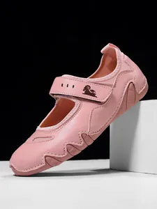 Detailed side view of pink Mary Jane sneakers with Velcro strap and stitched accents