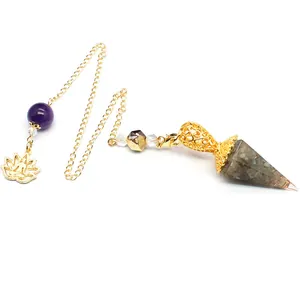 Detail view of hexagonal resin pendulum with natural crystal stones and lotus charm