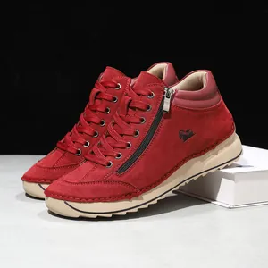 Detail view of red suede casual boots with side zipper and hand-stitched soft sole