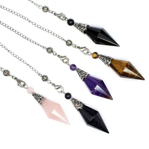 Close-up detail of assorted crystal dowsing pendulums featuring various gemstones and chains