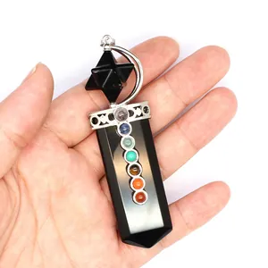 Macro detail of sword-shaped 7 chakra crystal pendant with Merkaba star and moon design