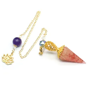 Detailed view of hexagonal crystal resin dowsing pendulum with gold filigree and lotus charm