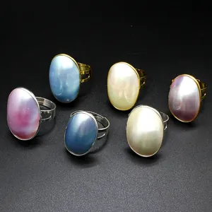 Detailed view of Mabe pearl rings with pearlescent blue, white, and pink finishes.