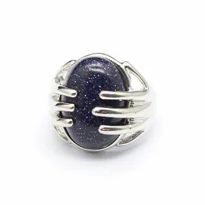 Detailed macro view of a silver hand-claw ring holding a sparkling blue goldstone.